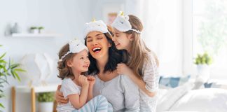 A happy mother and her two daughters after waking up from a comfortable night of sleeping on their new hybrid mattress.